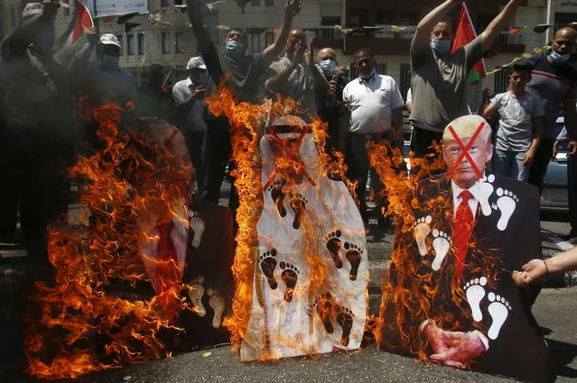 Palestinians burn pictures of U.S. President Donald Trump, Abu Dhabi Crown Prince Mohammed bin Zayed al-Nahyan and and Israeli Prime Minister Benjamin Netanyahu during a protest against the United Arab Emirates' deal with Israel, in the West Bank city of Nablus, Friday, August 14, 2020. (Photo by Majdi Mohammed/AP Photo)