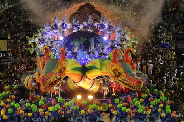 Performers from the Unidos de Vila Isabel samba school parade during carnival celebrations at the Sambadrome in Rio de Janeiro, Tuesday, February 12, 2013. Rio de Janeiro's samba schools vied for the title of the year's best in an over-the-top, all-night-long Carnival parade at the city's iconic Sambadrome. (Photo by Hassan Ammar/AP Photo)