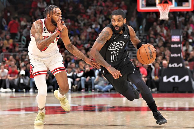 Kyrie Irving #11 of the Brooklyn Nets drives to the basket against Derrick Jones Jr. #5 of the Chicago Bulls during the first half at United Center on January 04, 2023 in Chicago, Illinois. (Photo by Michael Reaves/Getty Images)