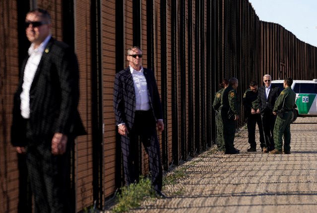Secret Service agents keep watch as U.S. President Joe Biden speaks with border patrol officers as he walks along the border fence during his visit to the U.S.-Mexico border to assess border enforcement operations, in El Paso, Texas, U.S., January 8, 2023. (Photo by Kevin Lamarque/Reuters)