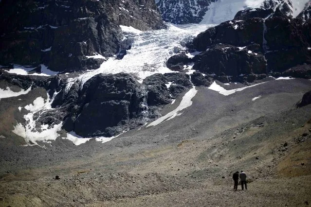 A view of “La Paloma” glacier next to the open pits of CODELCO's Andina and Anglo American's Los Bronces copper mines (not pictured) at Los Andes Mountain range, near Santiago city, November 17, 2014. (Photo by Ivan Alvarado/Reuters)