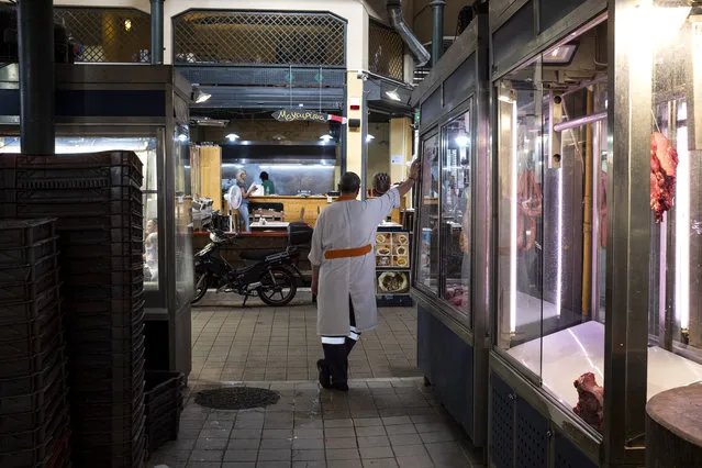 A butcher stands outside a butcher shop inside Athens' main meat market, in Athens, Thursday, September 3, 2020. Greece has suffered a huge drop in output in the second quarter of the year, plummeting 15.2% on an annual basis, but the government insisted the figures did not worsen the country's annual outlook. (Photo by Yorgos Karahalis/AP Photo)