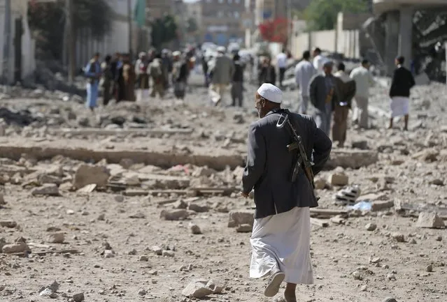 A Houthi militant walks at the site of Saudi-led air strikes in Yemen's capital Sanaa October 28, 2015. (Photo by Khaled Abdullah/Reuters)