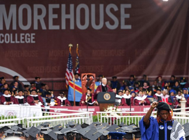A woman stands with her back turned and holding up her fist during a speech by U.S. President Joe Biden, during a Morehouse College commencement ceremony in Atlanta, Georgia, U.S., May 19, 2024. (Photo by Alyssa Pointer/Reuters)