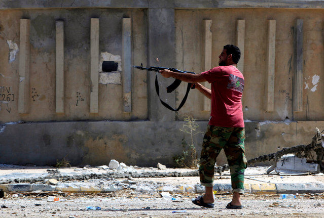 A fighter from Libyan forces allied with the U.N.-backed government fires a weapon as forces advance into the last area controlled by Islamic State in Sirte, Libya, October 13, 2016. (Photo by Ismail Zitouny/Reuters)
