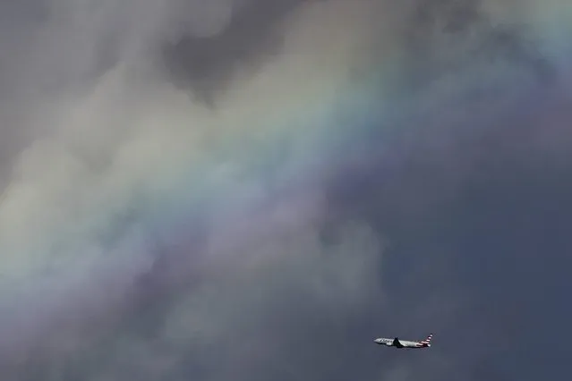 A rainbow is seen from Manhattan Beach pier as an airplane takes off from Los Angeles International Airport (LAX) during heavy rains in Manhattan Beach, California, December 12, 2014. The National Weather Service forecast the system to track through southwestern California late on Thursday and into Friday, brining the possibility of strong thunderstorms, as well as waterspouts and small tornadoes along the coast. (Photo by Patrick T. Fallon/Reuters)