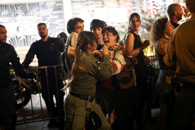 A protester confronts a police officer, during a demonstration against Israeli Prime Minister Benjamin Netanyahu's government and a call for the release of hostages in Gaza, amid the Israel-Hamas conflict, in Tel Aviv, Israel on June 22, 2024. (Photo by Eloisa Lopez/Reuters)