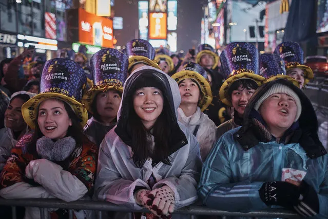 Revellers gather under the rain as they wait for the countdown during the New Year's Eve celebrations in Times Square on Saturday, December 31, 2022, in New York. (Photo by Andres Kudacki/AP Photo)
