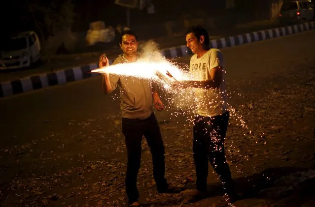 Men light firecrackers while celebrating the Hindu festival of Diwali, the annual festival of lights in New Delhi, India, November 11, 2015. (Photo by Adnan Abidi/Reuters)