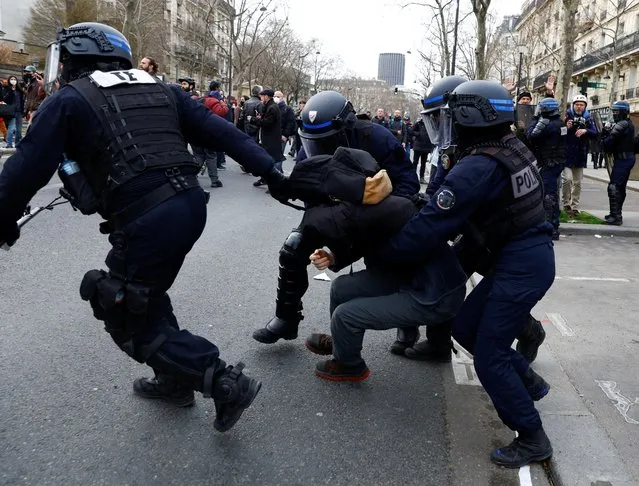 French police detain a protester during a demonstration against French government's pension reform plan in Paris, as part of the eighth day of national strike and protests in France on March 15, 2023. (Photo by Gonzalo Fuentes/Reuters)