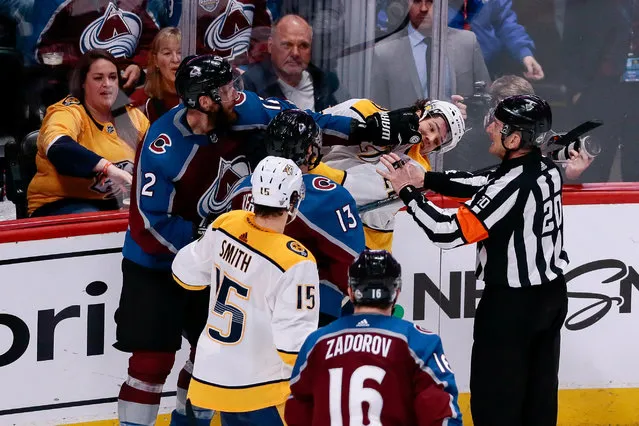 Referee Tim Peel (20) breaks up Colorado Avalanche defenseman Patrik Nemeth (12) and Nashville Predators left wing Kevin Fiala (22) in the second period in game six of the first round of the 2018 Stanley Cup Playoffs at the Pepsi Center in Denver, CO, USA on April 22, 2018. (Photo by Isaiah J. Downing/USA TODAY Sports)