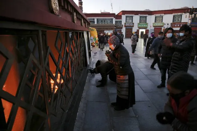 Pilgrims pray outside the Jokhang Temple in central Lhasa, Tibet Autonomous Region, China, at dawn November 20, 2015. (Photo by Damir Sagolj/Reuters)