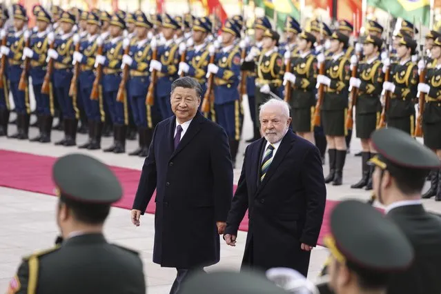 Brazilian President Luiz Inacio Lula da Silva, right, inspects an honor guard with Chinese President Xi Jinping during a welcome ceremony outside the Great Hall of the People in Beijing, China, Friday, April 14, 2023. (Photo by Ken Ishii/Pool Photo via AP Photo)