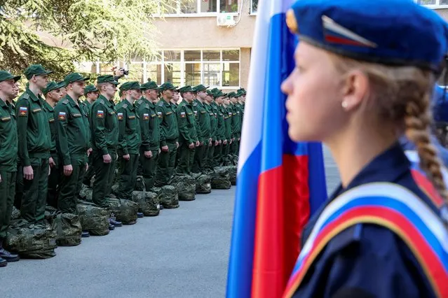 Russian conscripts called up for military service line up before their departure for garrisons as they gather at a recruitment centre in Simferopol, Crimea on April 25, 2023. (Photo by Alexey Pavlishak/Reuters)