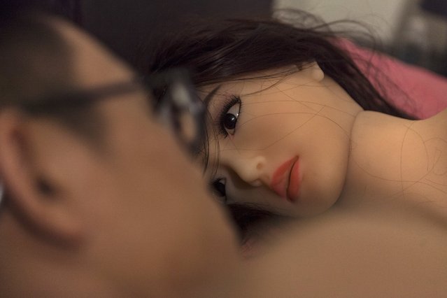 Chen interacts with his “smart” s*x doll as he lays in a bed in his home in Guangzhou, Guandong Province, China, 05 April 2018. (Photo by Aleksandar Plavevski/EPA/EFE)