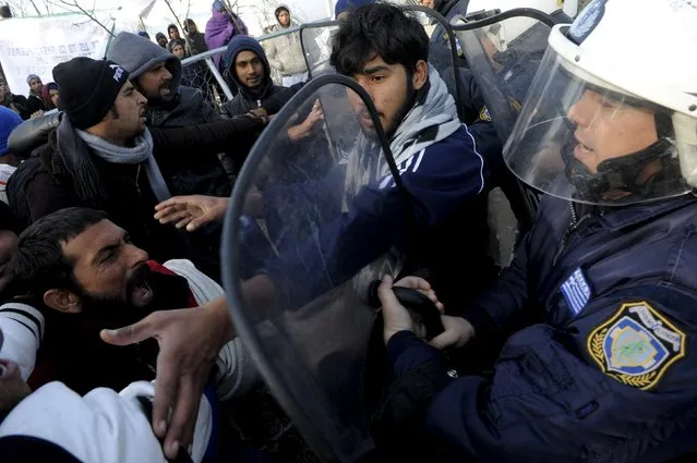 Stranded migrants scuffle with Greek police officers as they try to cross the Greek-Macedonian border, near the village of Idomeni, Greece, December 2, 2015. (Photo by Alexandros Avramidis/Reuters)