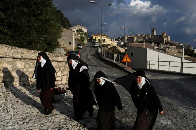 Nuns walk up to the entrance of a church in Castel del Monte, in the province of L'Aquila in Abruzzo, inside the national park of the Gran Sasso e Monti della Laga, Italy, September 8, 2016. (Photo by Siegfried Modola/Reuters)