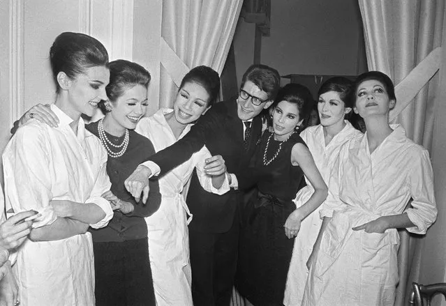 Yves Saint Laurent is photographed surrounded by models after presenting the first haute couture collection from his own fashion house, founded a few months earlier in partnership with Pierre Bergé. January 29, 1962. (Photo by AFP Photo)