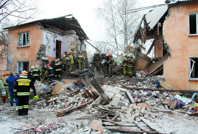 In this Sunday, November 6, 2016 photo, emergency rescue teams dig through rubble after an explosion at brick building in Ivanovo, 250 kilometers (150 miles) northeast of Moscow, Russia. Russian emergency officials say the explosion was caused by a gas leak in the apartment building shortly before dawn. (Photo by TASS/Barcroft Images)