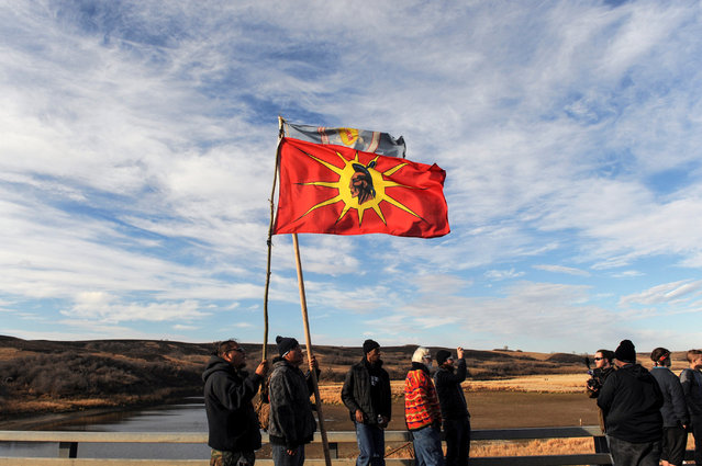 Protesters fly flags during a protest of the Dakota Access pipeline near the Standing Rock Indian Reservation near Cannon Ball, North Dakota November 6, 2016. (Photo by Stephanie Keith/Reuters)