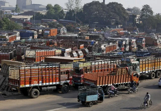 Trucks are seen parked in an open plot near a national highway on the outskirts of Ahmedabad, India, December 2, 2015. India will force all commercial trucks more than 15 years old off the road from April and is reviewing how it checks vehicle emissions, a senior transport official said, as the government tries to curb soaring urban air pollution. (Photo by Amit Dave/Reuters)