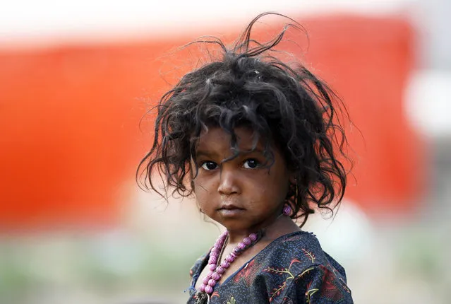 A displaced Yemeni child looks on at a make-shift camp for displaced people where they are taking shelter in an area on the outskirts of Sanaa on May 21, 2018. The United Nations says the offensive by the Saudi Arabia led coalition has displaced more than 100,000 people in the past six months. (Photo by Mohammed Huwais/AFP Photo)