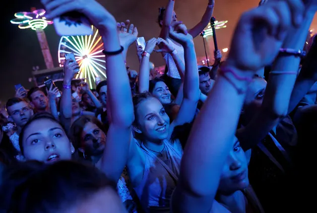 Festivalgoers attend the Balaton Sound music festival in Zamardi, Hungary, July 5, 2018. Balaton Sound is one of Europe's largest open air electronic music festivals. Held annually since 2007 on the southern bank of Lake Balaton, Hungary, it features live acts and DJ's from all around the world, from established artists to new names. The event was co-created by the organizers of Sziget Festival. (Photo by Bernadett Szabo/Reuters)