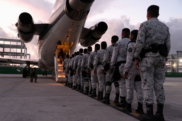 Members of Mexico's National Guard queue to board a plane bound for the northern border after Mexican President Claudia Sheinbaum agreed with U.S. President Donald Trump to bolster border enforcement efforts in response to Trump's demand to crack down on immigration and drug smuggling, at the Cancun International Airport, in the metropolitan area of Cancun, Mexico on February 4, 2025. (Photo by Paola Chiomante/Reuters)