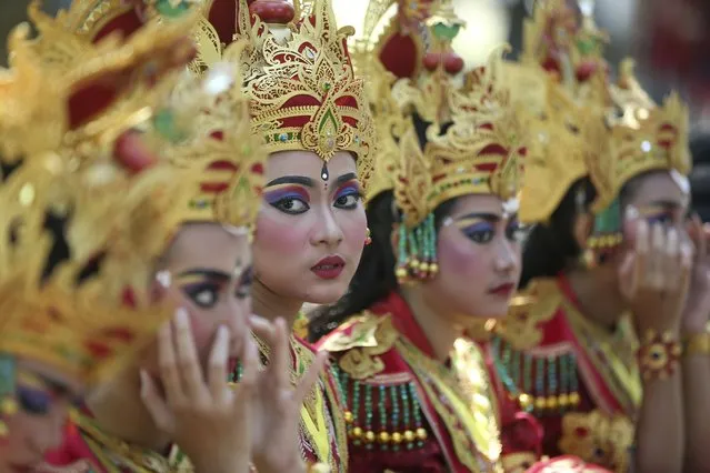 Female dancers line up before they perform during the opening of Bali Arts Festival in Bali, Indonesia, Sunday, June 18, 2023. The island of Bali is currently holding a month-long annual Bali Arts Festival from June 18 until July 16. (Photo by Firdia Lisnawati/AP Photo)