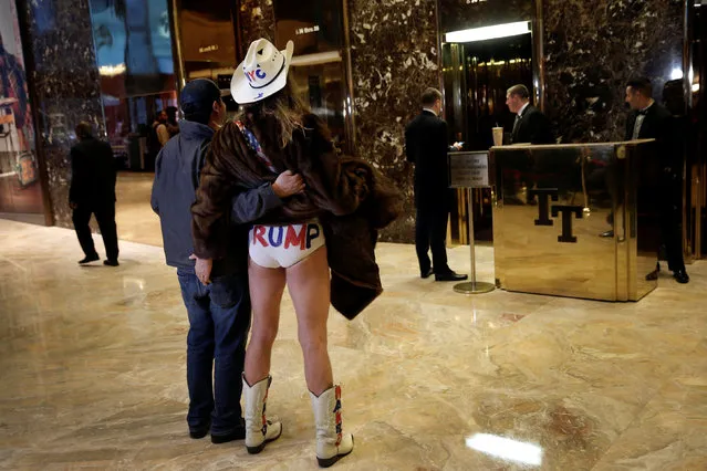 Robert Burck known as the original “Naked Cowboy” stands with a man for a picture inside the lobby at Trump Tower where U.S. President Elect Donald Trump lives in New York, U.S. November 18, 2016. (Photo by Mike Segar/Reuters)