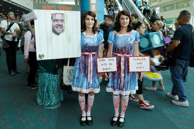 Samantha Sherman (R) and Gayle Hooker dressed as the twins from the movie The Shinning attends opening day of pop culture convention Comic Con International in San Diego, USA on Thursday, July 19, 2018. (Photo by Mike Blake/Reuters)