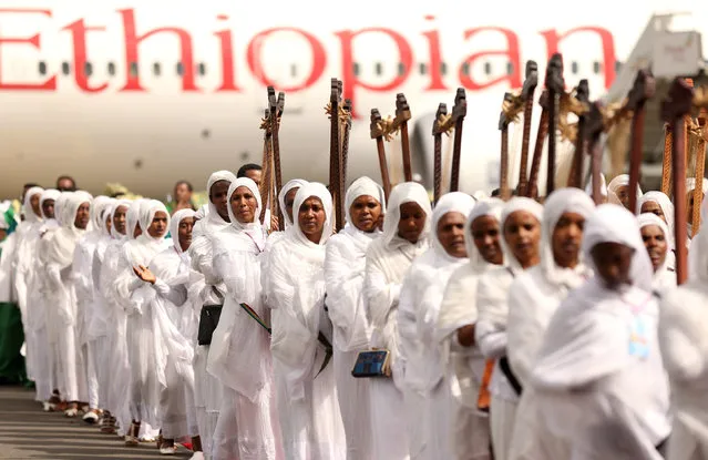 Choir members play harps during a welcome ceremony for the 4th Patriarch of Ethiopian Orthodox Tewahdo Church, Abune Merkorios upon returning from exile at the Bole airport in Addis Ababa, Ethiopia August 1, 2018. (Photo by Tiksa Negeri/Reuters)