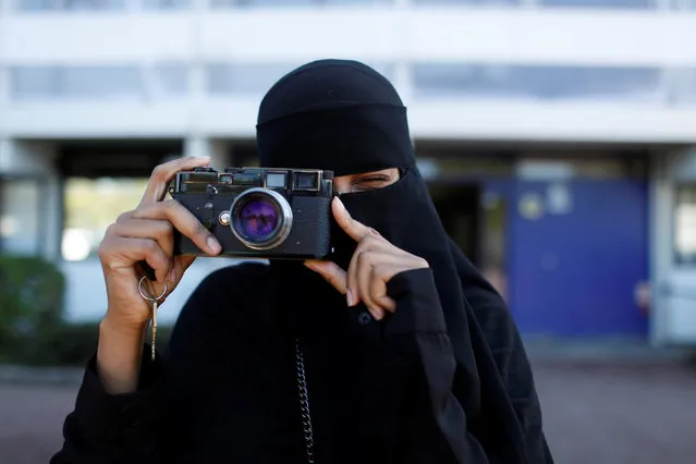Amina, 24, a wearer of the niqab and a member of the group Kvinder I Dialog (Women In Dialogue), uses a camera in Copenhagen, Denmark, July 20, 2018. (Photo by Andrew Kelly/Reuters)