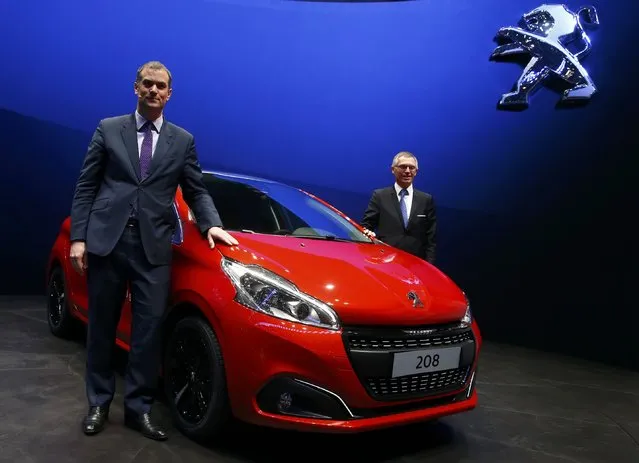 Maxime Picat, Peugeot Brand CEO and Carlos Tavares, CEO of PSA Peugeot Citroen (R) pose with a Peugeot 208 during the first press day ahead of the 85th International Motor Show in Geneva March 3, 2015. REUTERS/Arnd Wiegmann   