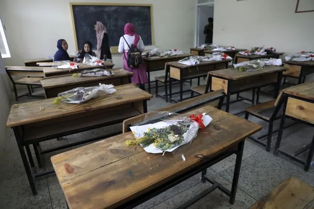 Bouquets of flowers lie on empty desks as a tribute to those killed in the brutal May 8 bombing of the Syed Al-Shahda girls school, in Kabul, Afghanistan, Sunday, May 16, 2021. On Sunday parents of scores of young girls killed in the bombing demonstrated in the mostly Shiite neighborhood of Dasht-e-Barchi to demand the government provide them with greater security. They said 90 people were killed. (Photo by Rahmat Gul/AP Photo)