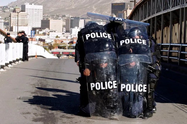 U.S. Custom and Border Protection agents with full riot gear take part in a drill to protect the crossing gates against people who want to cross the border illegally on the international bridge between Mexico and the U.S., in Ciudad Juarez, Mexico October 29, 2018. (Photo by Jose Luis Gonzalez/Reuters)