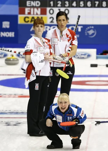 Canada's Dawn McEwen (top L) and Jill Officer (top R) watch as Finland's Sanna Puustinen shouts to her team mates during their curling round robin game at the World Women's Curling Championships in Sapporo March 14, 2015. (Photo by Thomas Peter/Reuters)
