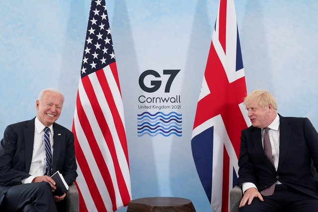 U.S. President Joe Biden laughs while speaking with Britain's Prime Minister Boris Johnson during their meeting, ahead of the G7 summit, at Carbis Bay, Cornwall, Britain on June 10, 2021. (Photo by Kevin Lamarque/Reuters)