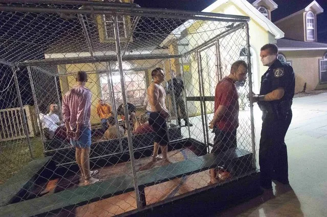 People are taken into custody at the Bay County Sheriff's Office mobile booking unit during spring break festivities in Panama City Beach, Florida March 12, 2015. (Photo by Michael Spooneybarger/Reuters)