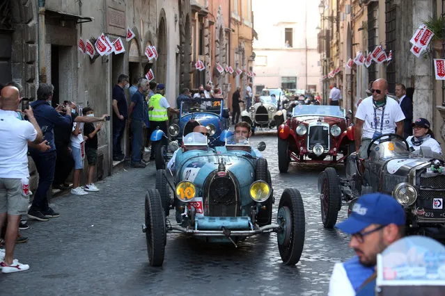 Vintage cars drive through Civita Castellana during the Mille Miglia (1,000 Miles) classic and vintage cars rally, Italy, 18 Jun​e 2021. (Photo by Matteo Bazzi/EPA/EFE)