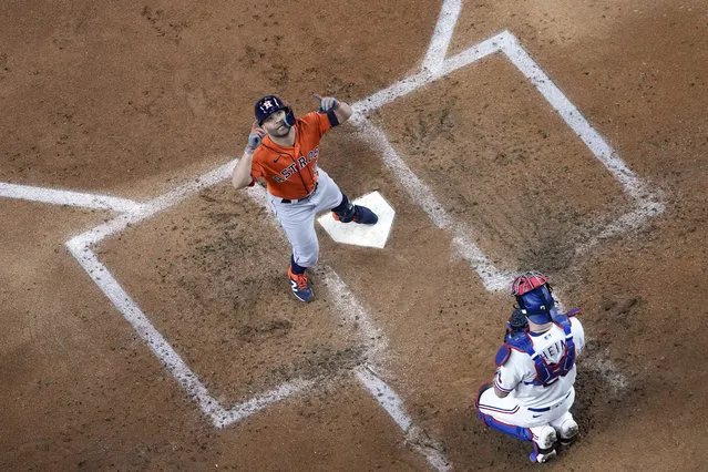 Houston Astros' Jose Altuve, left, celebrates after hitting a home run as Texas Rangers catcher Jonah Heim kneels behind home plate during the third inning in Game 3 of the baseball American League Championship Series Wednesday, October 18, 2023, in Arlington, Texas. (Photo by Godofredo A. Vasquez/AP Photo)