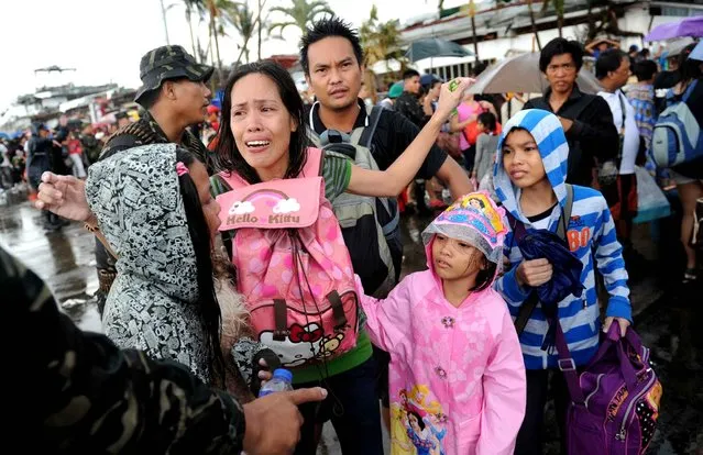 A mother cries after her family failed to take a flight on a C-130 military plane out of Tacloban. (Photo by Ted Aljibe/AFP Photo)