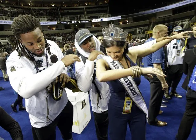 Carolina Panthers' Ryan Delaire and Bene' Benwikere dance with Miss Universe Pia Alonzo Wurtzbach during Opening Night for the NFL Super Bowl 50 football game Monday, February 1, 2016, in San Jose, Calif. (Photo by Jeff Chiu/AP Photo)
