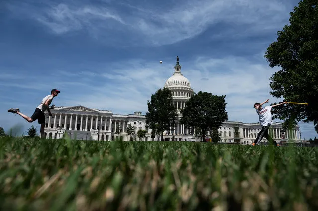 Brian Scott plays Wiffle Ball with his son Jacob, 12, outside of the reopened East Front of the U.S. Capitol in Washington, DC, on July 10, 2021. (Photo by Craig Hudson for The Washington Post)