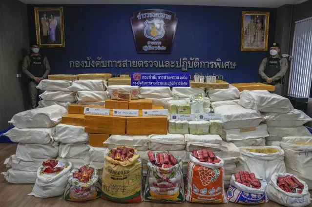 Thai police officers stand behind packages containing seized crystal meth, methamphetamine, heroin during a news conference Bangkok, Thailand, Thursday, September 28, 2023. Police in Thailand said Thursday they made one of the country’s biggest ever seizures of illicit drugs, a haul including methamphetamine, crystal meth and heroin, with a total estimated street value of about 300 million baht ($8.2 million). (Photo by Sakchai Lalit/AP Photo)