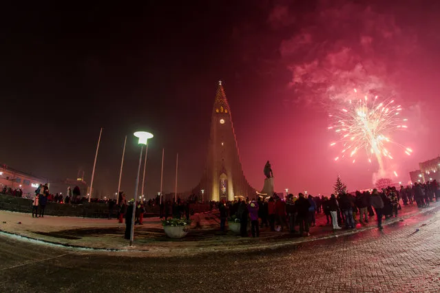 People gather at Hallgrims church to celebrate the New Year in Reykjavik, Iceland, January 1, 2017. (Photo by Reuters/Geirix)