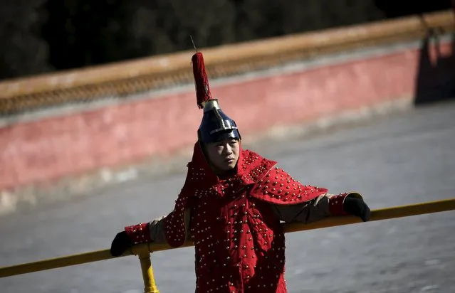 A paramilitary policeman, dressed as a soldier from the Qing Dynasty, waits to take part in a rehearsal for the upcoming temple fair, adapted from an ancient Qing Dynasty ceremony where emperors prayed for good harvest and fortune, to celebrate the upcoming Lunar New Year of the Monkey at Ditan Park (the Temple of Earth), in Beijing, China, February 6, 2016. (Photo by Jason Lee/Reuters)