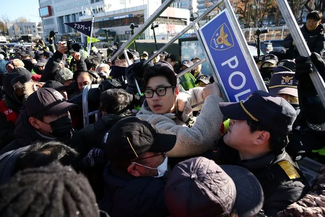 Dog farmers scuffle with South Korean policemen during a protest to demand the government to scrap plans to pass a bill to enforce a ban on eating dog meat, in front of the Presidential Office in Seoul, South Korea on November 30, 2023. (Photo by Kim Hong-Ji/Reuters)