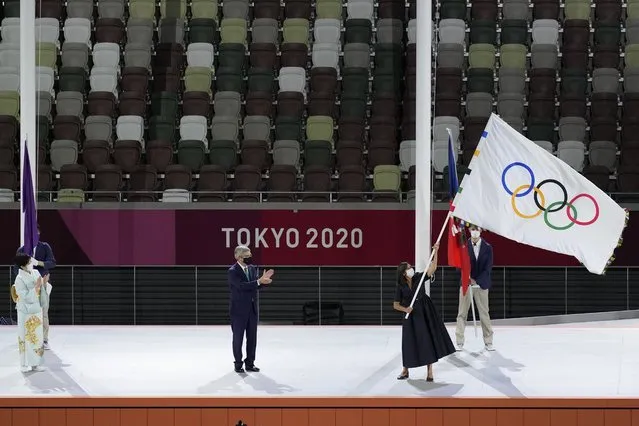 Paris mayor Anne Hidalgo, right, holds the Olympic flag next International Olympic Committee's President Thomas Bach, center, and Tokyo Gov. Yuriko Koike, left, during the closing ceremony in the Olympic Stadium at the 2020 Summer Olympics, Sunday, August 8, 2021, in Tokyo, Japan. (Photo by Lee Jin-man/AP Photo)