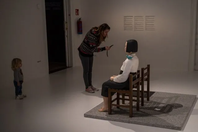 A visitor takes photos to the statue of A Girl of Peace, by Kim Eun-Sung & Kim Seo-Kyung at Barcelona's Museum of Forbidden Art in Barcelona, Spain, Wednesday, November 8, 2023. Exhibited as part of the Aichi Triennale 2019 in Japan, the artwork received threats of attack for being anti-Japanese propaganda. The Exhibition was closed but reaction against its censorship forced it to be reopened. This artwork has caused various diplomatic incidents between Japan and South Korea. For its creators, it is a icon of peace. A new museum in Barcelona is offering a second chance to controversial artworks that have suffered censorship for religious, sexual, political or commercial reasons. (Photo by Emilio Morenatti/AP Photo)